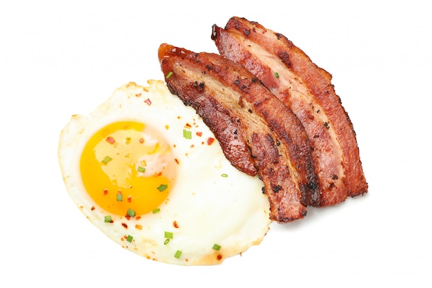 Fried eggs and bacon with spices isolated 