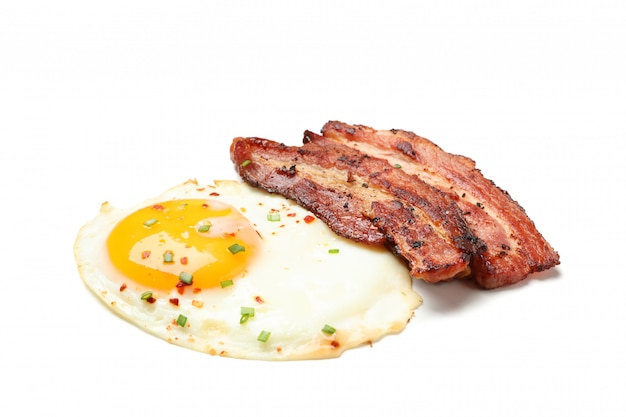 Fried eggs and bacon with spices isolated 