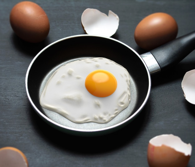 Fried eggs in a frying pan and egg shell