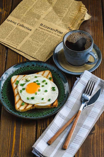 Fried eggs on toast with hot coffee