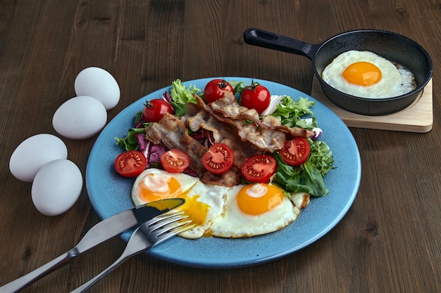 Fried eggs with bacon lettuce and cherry tomatoes