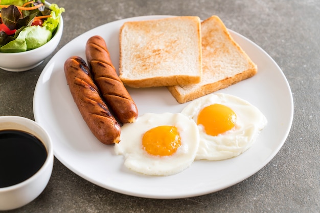 fried eggs with sausage and bread