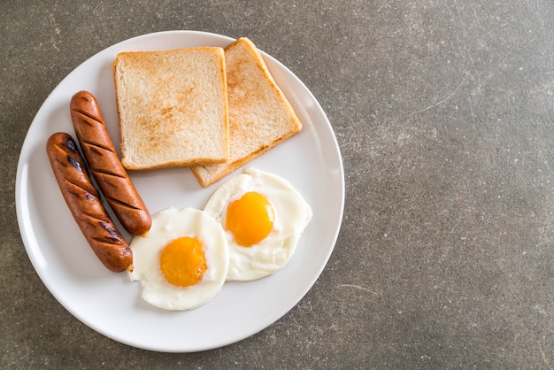 fried eggs with sausage and bread