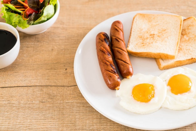 fried eggs with sausage and bread