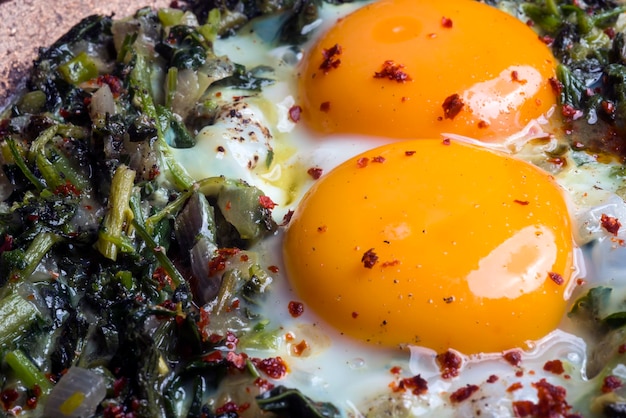 Fried eggs with spinach, Turkish foods vegetables.