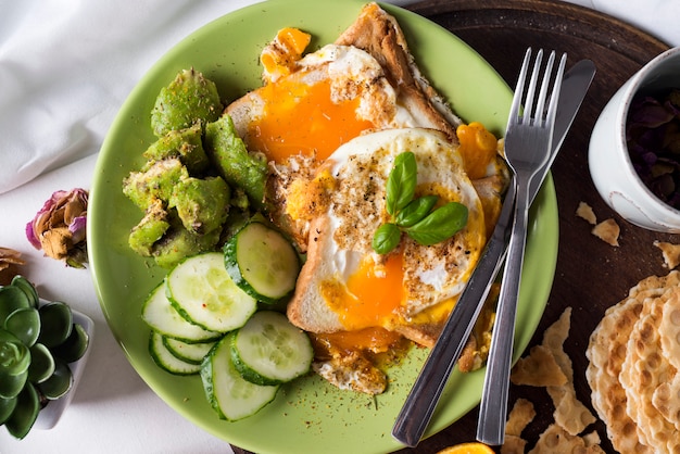 Fried eggs with toasts and tea in bed