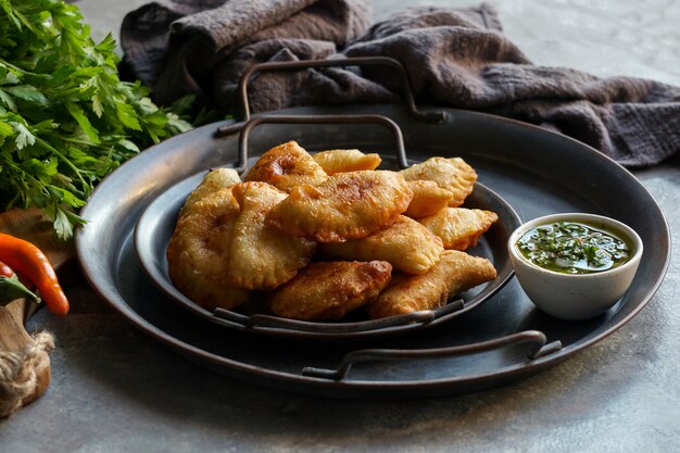 Fried empanadas with sauce. top view