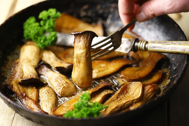 Fried eringi mushrooms in a frying pan