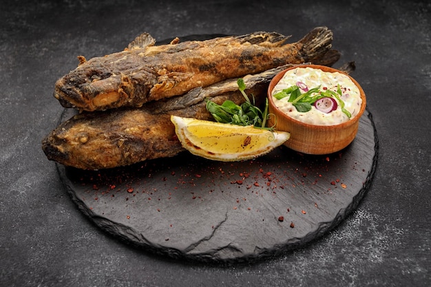 Fried fish Black Sea goby on a dark background