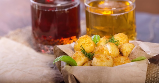 Fried fish and cheese balls with lemon and greens