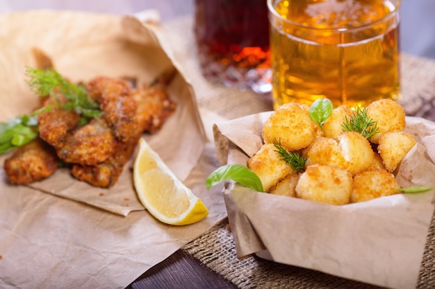 Fried fish and cheese balls with lemon and greens