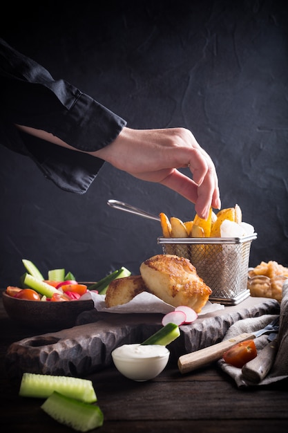 Fried fish fillet with baked potatoes