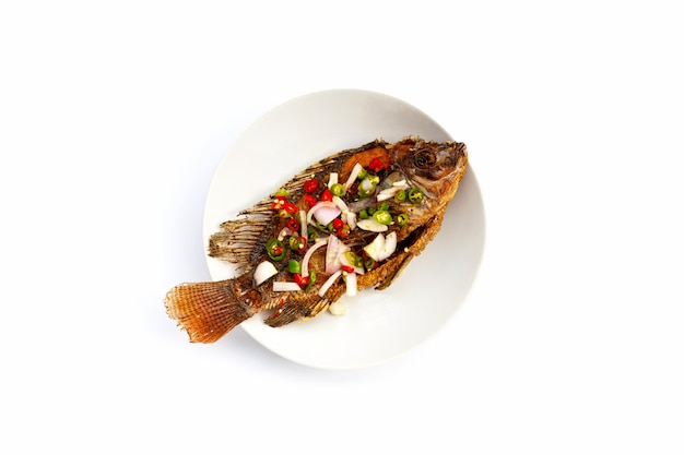 Fried fish in white plate on white background