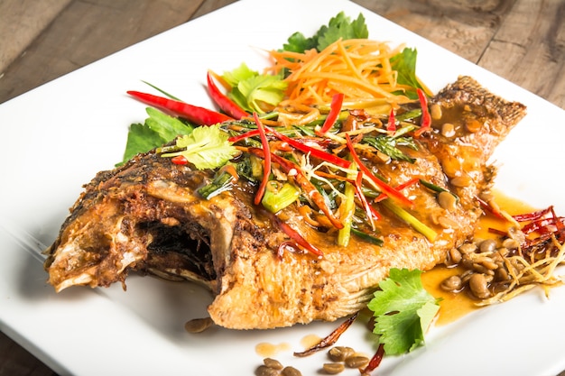 fried fish with fresh herbs and sweet spicy sauce