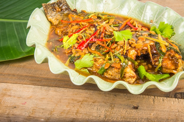 fried fish with fresh herbs and sweet spicy sauce