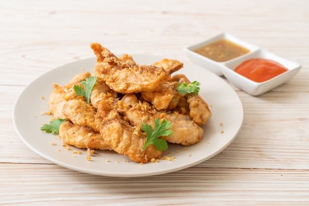 fried fish with garlic on plate