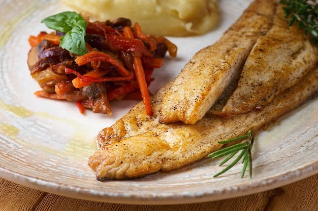 Fried fish with mashed potatoes and vegetable