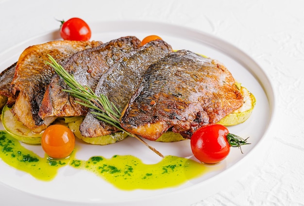 fried fish with vegetables on plate