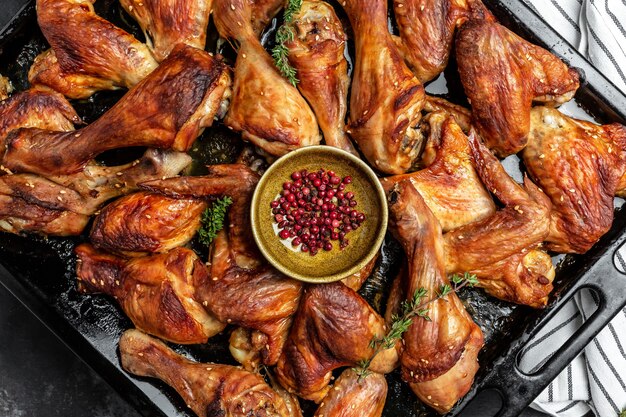 Fried golden chicken wings and legs on baking tray