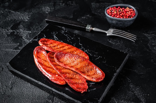 Fried on grill Sucuk beef meat sausage Black background Top view