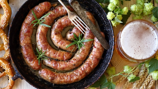 Fried homemade sausages with spices in a pan