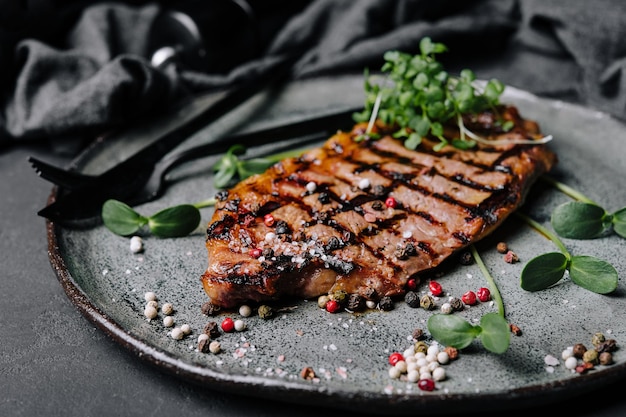 Fried juicy steaks with herbs and spices on plate