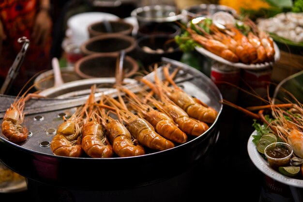 Fried king shrimps seafood by fire and BBQ Flames Restaurant Barbecue at the night market