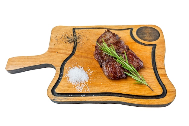 Fried meat steak with rosemary served on a wooden board with salt Appetizing popular dish Closeup Top view Isolated on white background