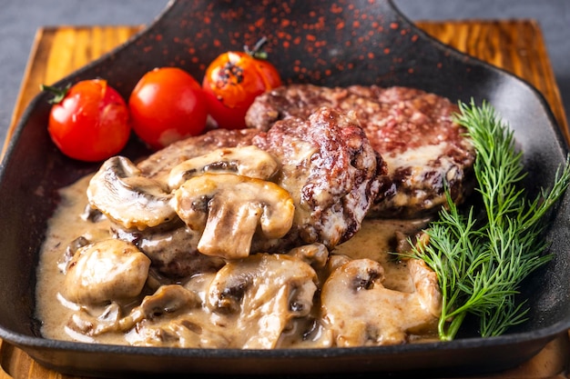 Fried meat with mushrooms and sauce Closeup