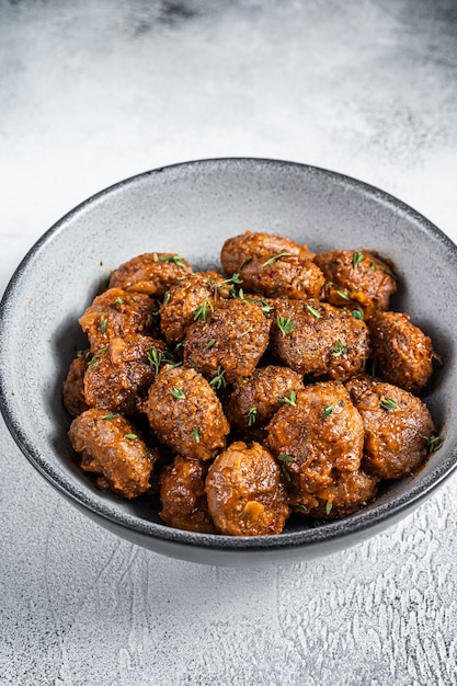Fried Meatballs in tomato sauce from ground beef and pork meat. White background. Top view.