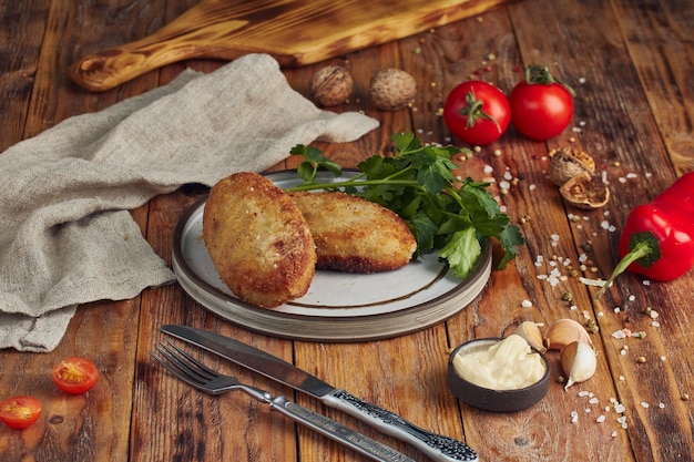 Fried minced meat (meat cutlet) on plate on wooden table