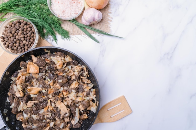 Fried morel mushrooms in olive oil in a frying pan copy space