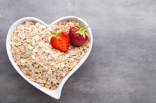 Fried oat flakes in a heart bowl.