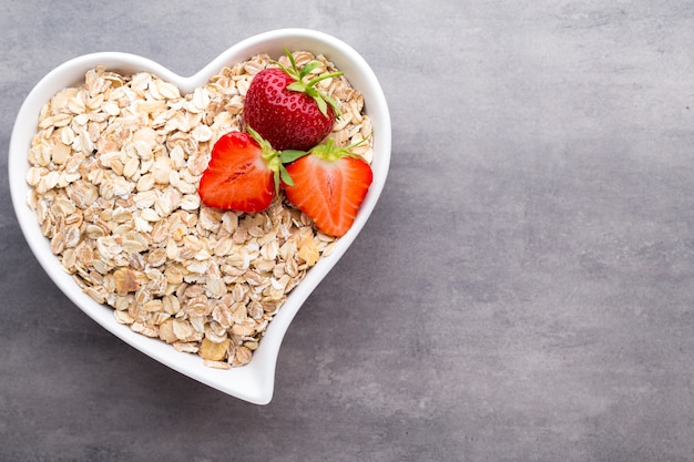 Fried oat flakes in a heart bowl.