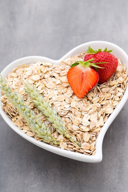 Fried oat flakes in a heart bowl.