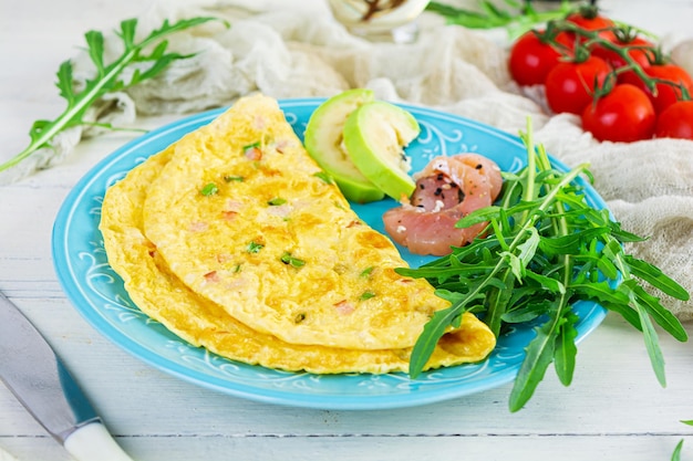 Fried omelette with ham onion and herbs Breakfast with scrambled eggs