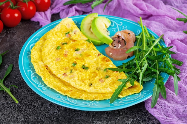 Fried omelette with ham onion and herbs Breakfast with scrambled eggs