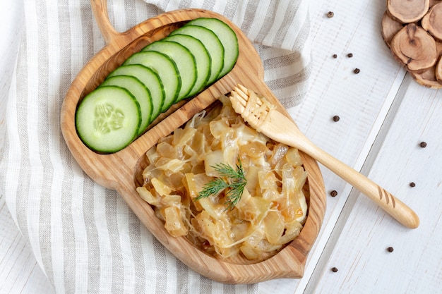 Fried onion with cheese on a wooden plate