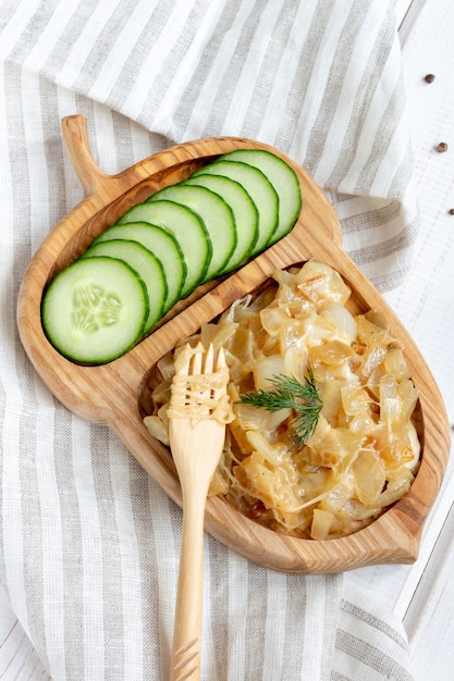 Fried onion with cheese on a wooden plate