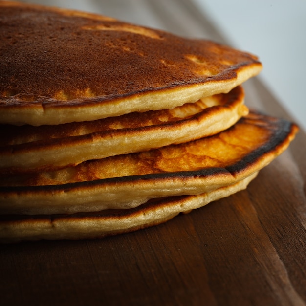 Fried pancakes on a wooden surface.