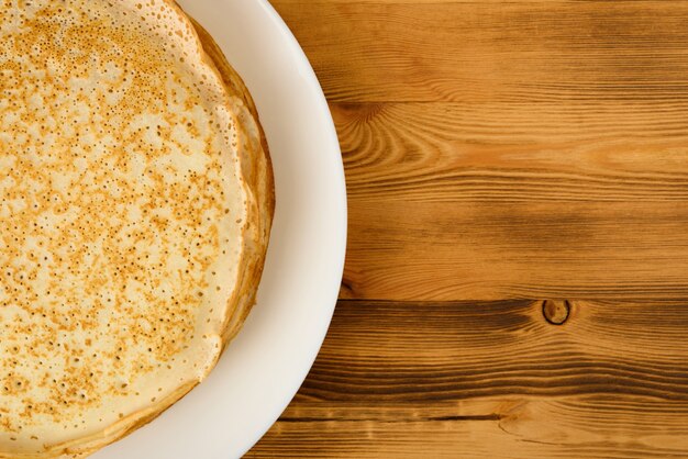 Fried pancakes on wooden table. Top view.