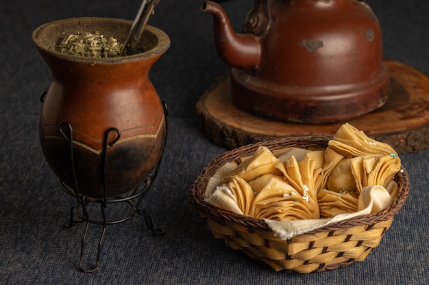 Fried pastries stuffed with sweet potato or quince with yerba mate and a kettle Typical Argentine food