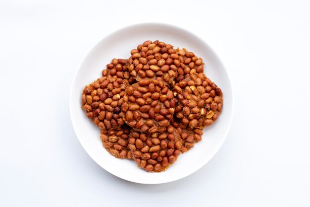 Fried peanut cookies in white plate on white background.