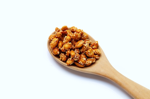 Fried peanuts with sugar and sesame seeds on white