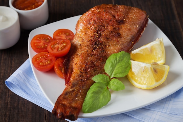 Fried perch with tomatoes and basil