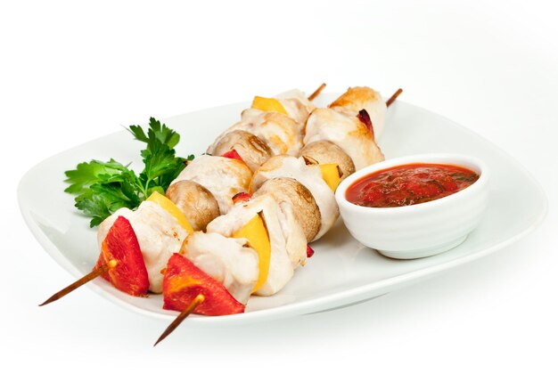 Fried pieces of a hen with sauce on a white background