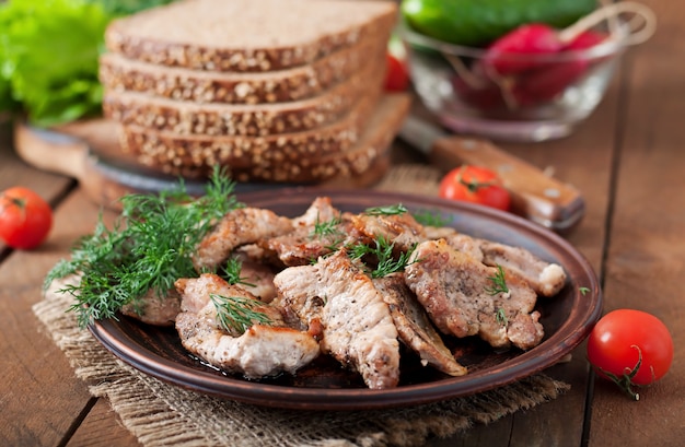 Fried pieces meat and rye bread for sandwiches