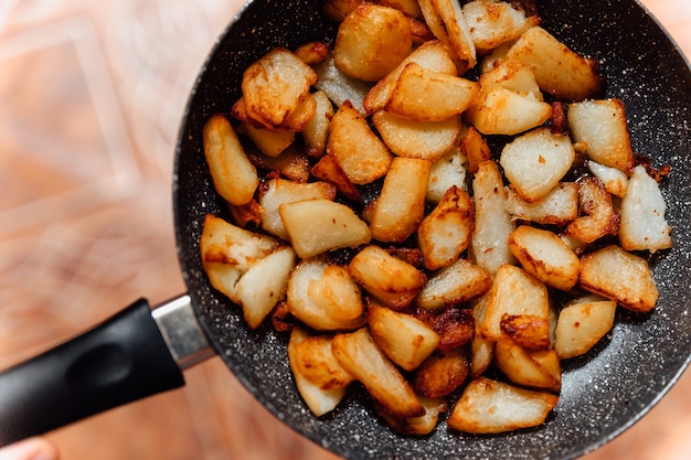 Fried pieces of potato in the pan