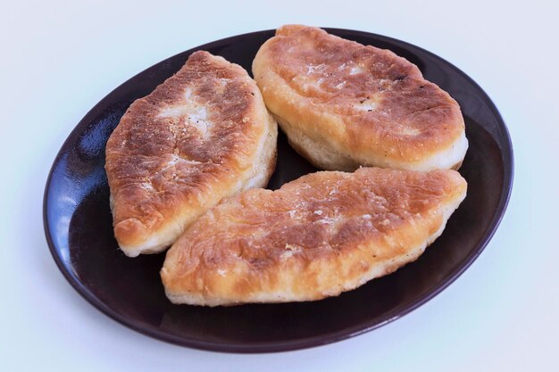 Fried pies with filling on a white table