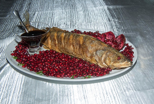 Fried pike-perch fish sliced with pomegranate sauce name\
narsharab sweet and sour sauce